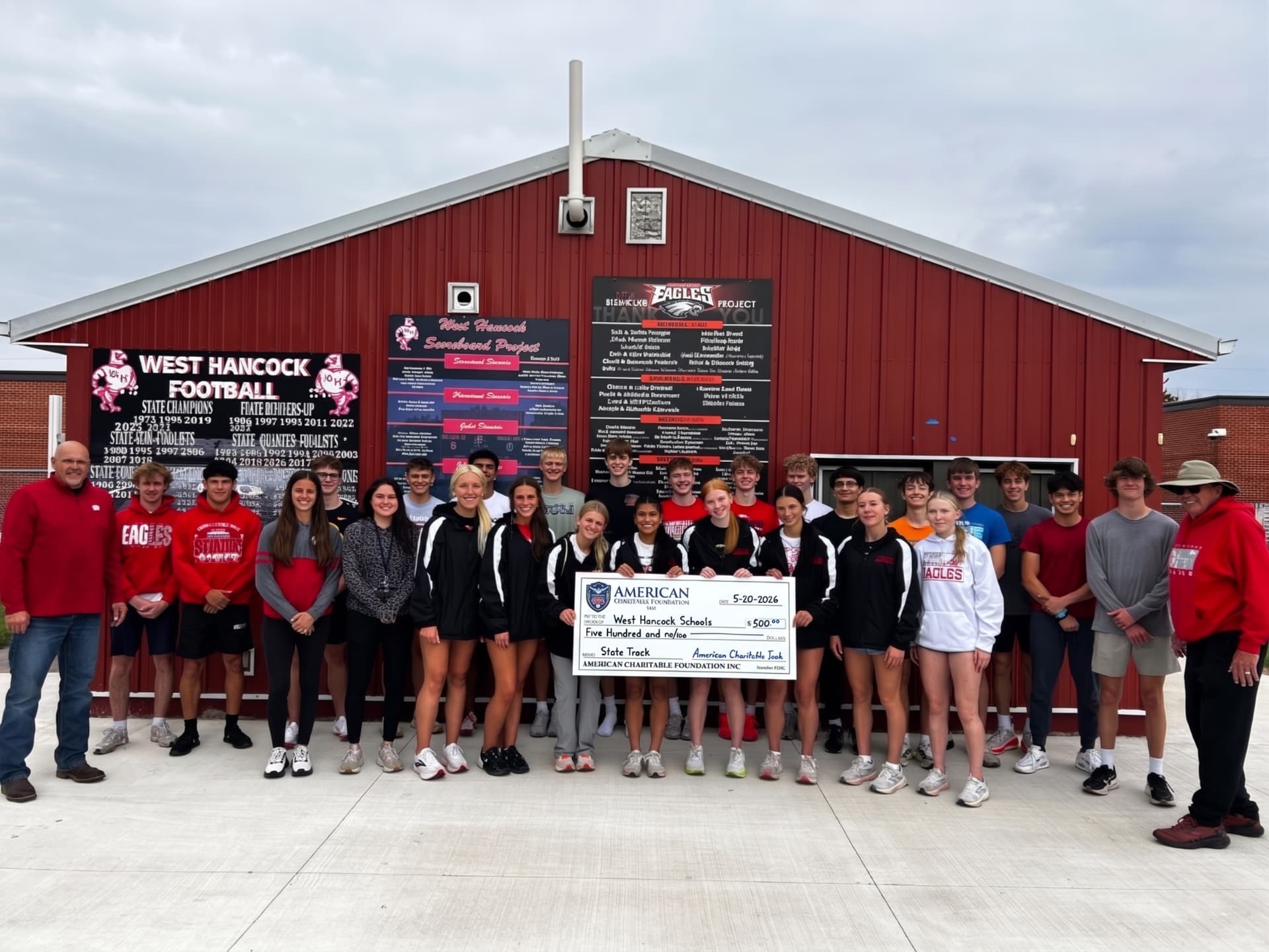 A large group of students and coaches presenting an ACF grant check outside the West Hancock Schools field house